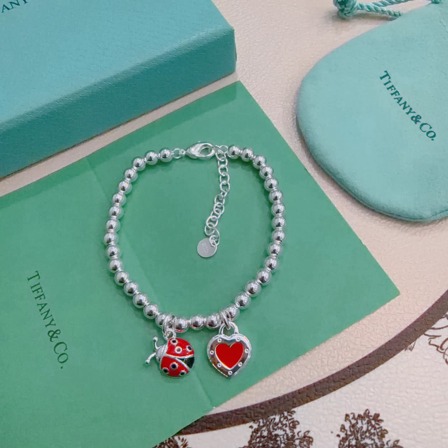 Tiffany & Co. Silver Bead Bracelet with Ladybug and Heart Charms
